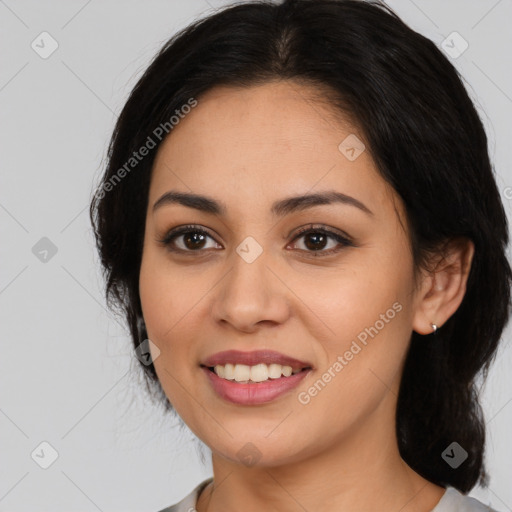 Joyful latino young-adult female with medium  brown hair and brown eyes