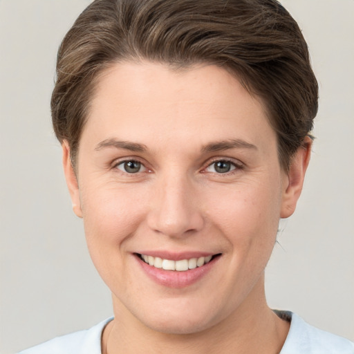 Joyful white young-adult female with short  brown hair and brown eyes