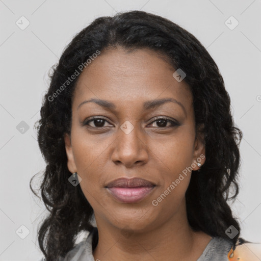 Joyful black young-adult female with long  black hair and brown eyes