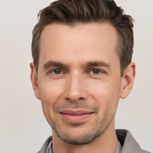 Joyful white adult male with short  brown hair and brown eyes