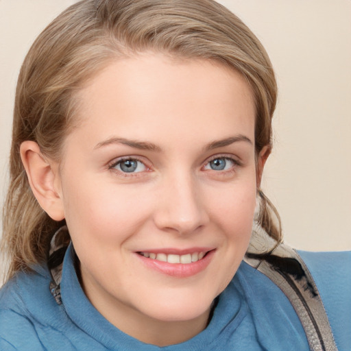 Joyful white young-adult female with medium  brown hair and blue eyes