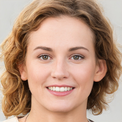 Joyful white young-adult female with medium  brown hair and green eyes