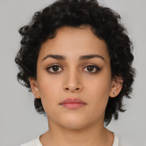 Neutral latino young-adult female with medium  brown hair and brown eyes
