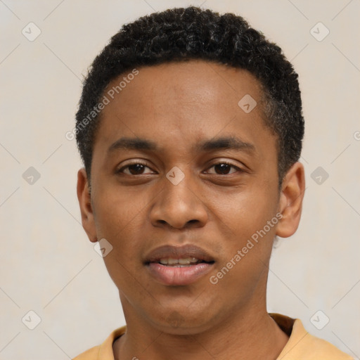 Joyful black young-adult male with short  black hair and brown eyes