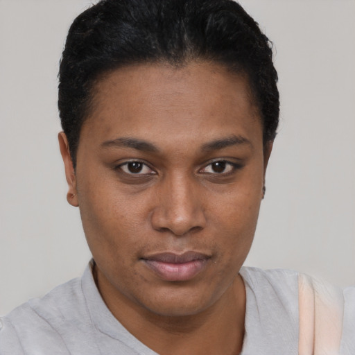 Joyful black young-adult female with short  black hair and brown eyes