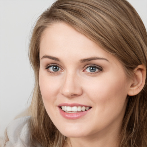 Joyful white young-adult female with long  brown hair and grey eyes