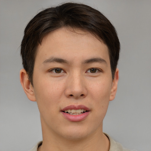 Joyful asian young-adult male with short  brown hair and brown eyes