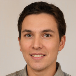 Joyful white adult male with short  brown hair and brown eyes