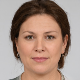 Joyful white adult female with medium  brown hair and grey eyes