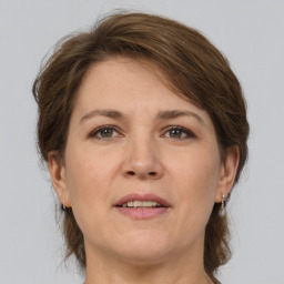 Joyful white adult female with medium  brown hair and brown eyes