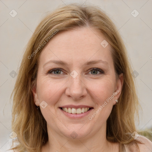 Joyful white adult female with medium  brown hair and blue eyes