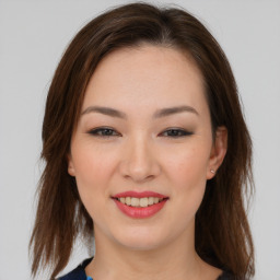 Joyful asian young-adult female with medium  brown hair and brown eyes