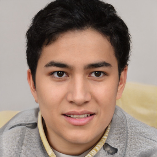 Joyful latino young-adult male with short  brown hair and brown eyes