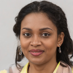 Joyful black young-adult female with medium  brown hair and brown eyes