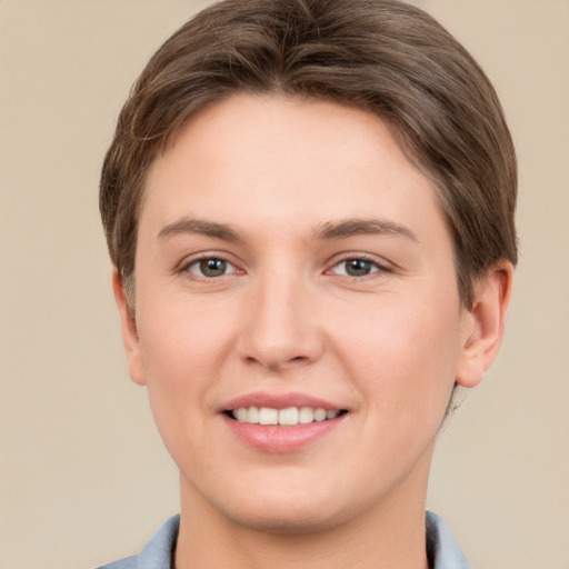 Joyful white young-adult female with short  brown hair and grey eyes