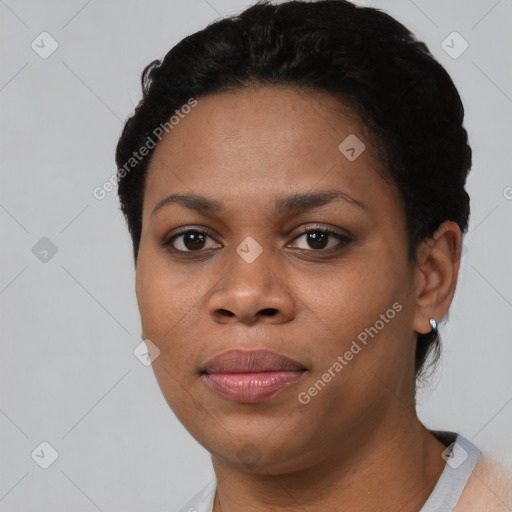 Joyful black young-adult female with short  black hair and brown eyes