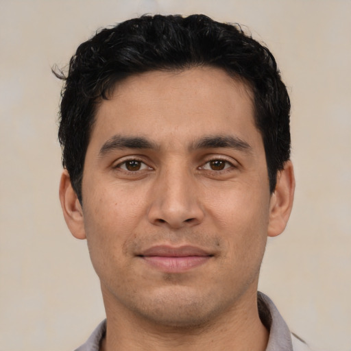 Joyful asian young-adult male with short  black hair and brown eyes