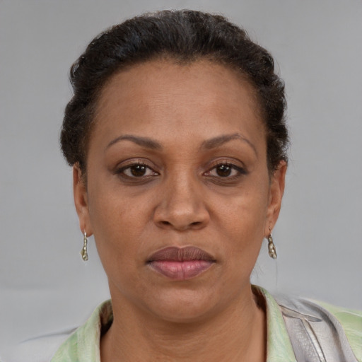 Joyful latino adult female with short  brown hair and brown eyes