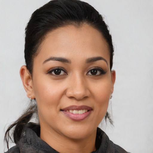 Joyful latino young-adult female with medium  brown hair and brown eyes