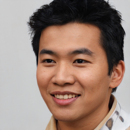 Joyful asian young-adult male with short  black hair and brown eyes