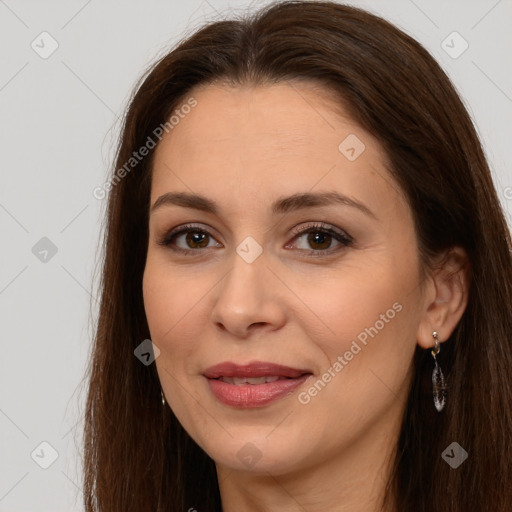 Joyful white adult female with long  brown hair and brown eyes