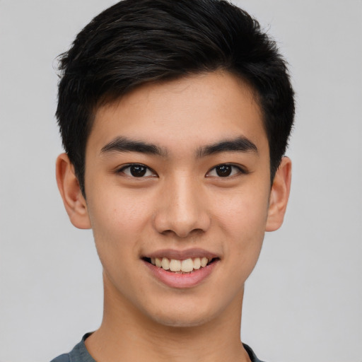 Joyful asian young-adult male with short  black hair and brown eyes