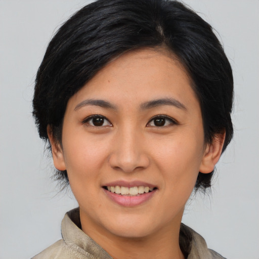 Joyful asian young-adult female with medium  black hair and brown eyes