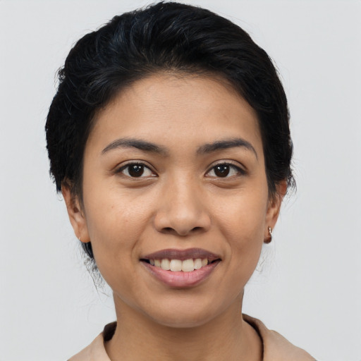 Joyful latino young-adult female with medium  black hair and brown eyes