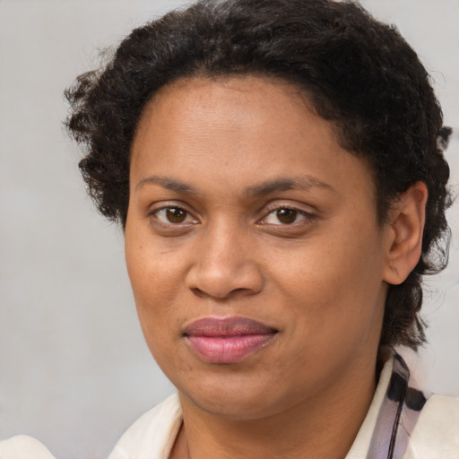 Joyful black adult female with short  brown hair and brown eyes