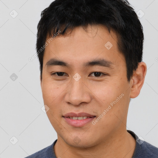 Joyful asian young-adult male with short  brown hair and brown eyes