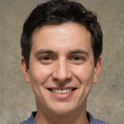 Joyful white adult male with short  brown hair and brown eyes
