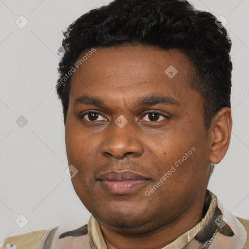 Joyful black young-adult male with short  black hair and brown eyes
