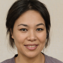 Joyful asian adult female with medium  brown hair and brown eyes