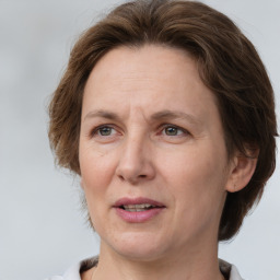 Joyful white adult female with medium  brown hair and grey eyes