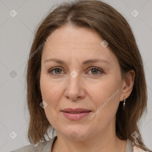 Joyful white adult female with medium  brown hair and grey eyes