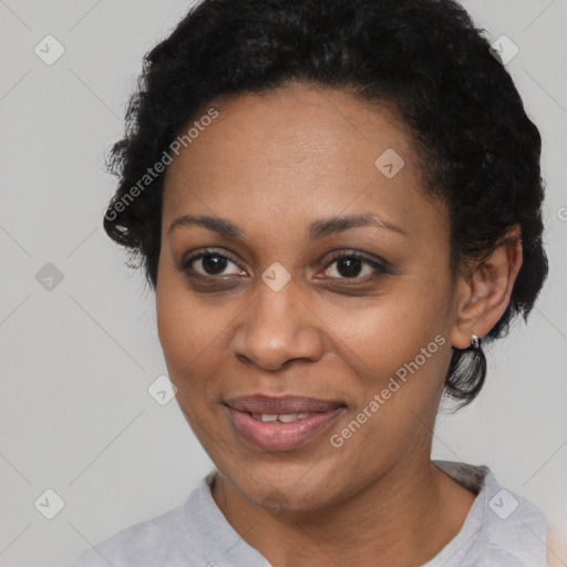 Joyful black adult female with short  black hair and brown eyes