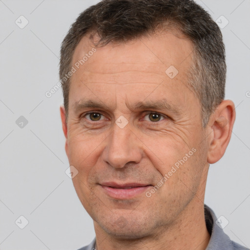 Joyful white adult male with short  brown hair and brown eyes