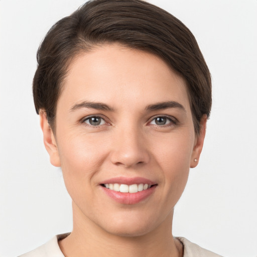 Joyful white young-adult female with short  brown hair and brown eyes