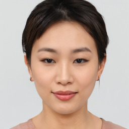 Joyful asian young-adult female with short  black hair and brown eyes