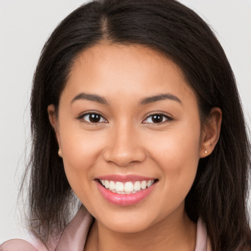 Joyful white young-adult female with long  brown hair and brown eyes