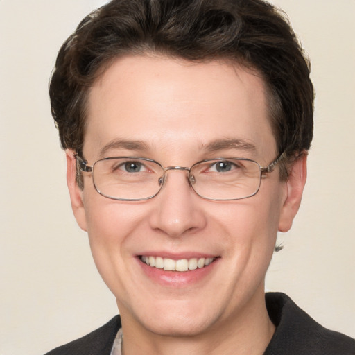 Joyful white adult male with short  brown hair and grey eyes