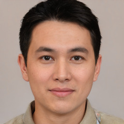 Joyful asian young-adult male with short  brown hair and brown eyes