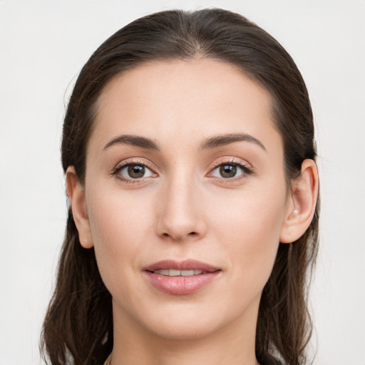 Joyful white young-adult female with long  brown hair and grey eyes