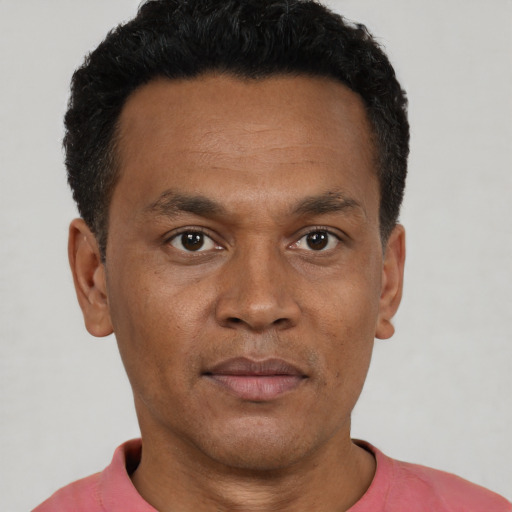 Neutral black adult male with short  black hair and brown eyes