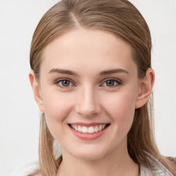 Joyful white young-adult female with long  brown hair and blue eyes