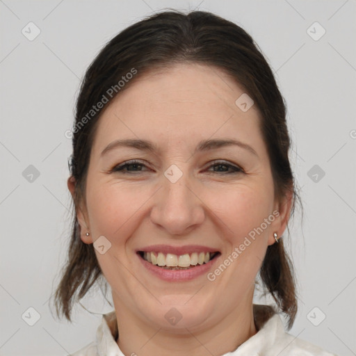 Joyful white adult female with medium  brown hair and brown eyes