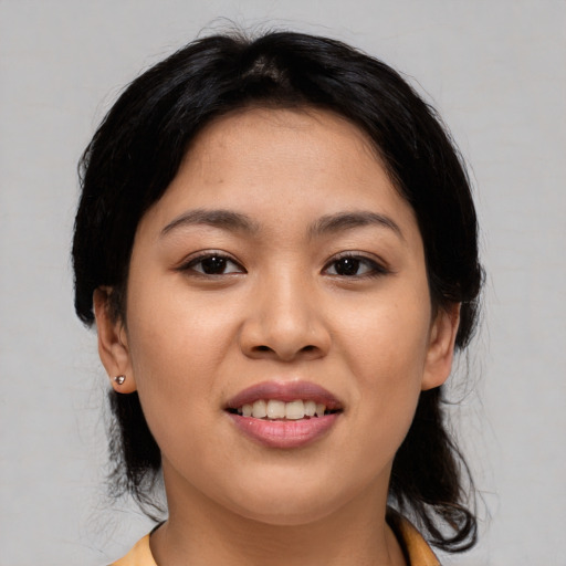 Joyful asian young-adult female with medium  black hair and brown eyes