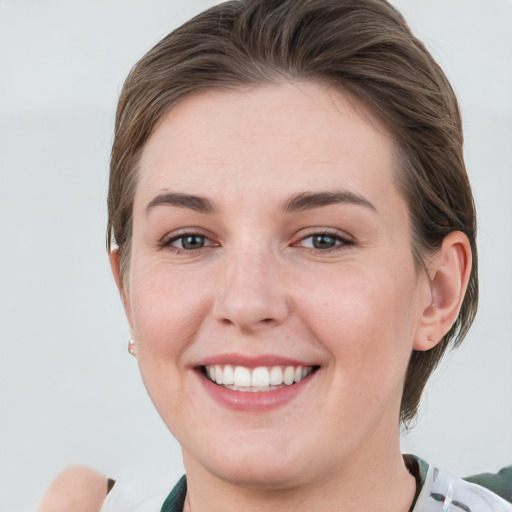 Joyful white young-adult female with medium  brown hair and grey eyes