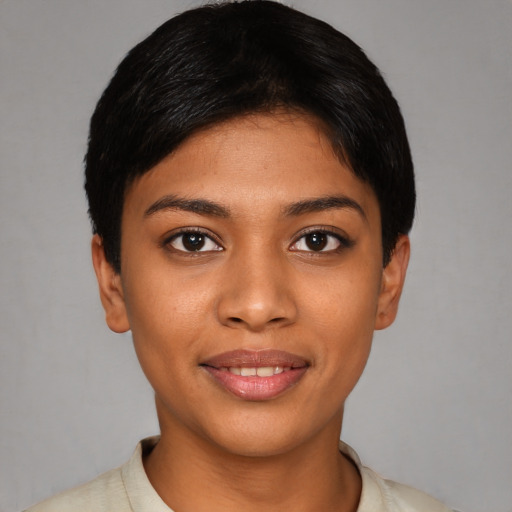 Joyful latino young-adult female with short  black hair and brown eyes
