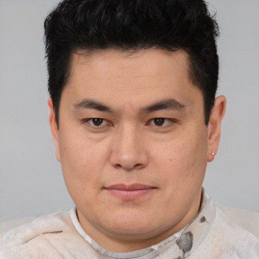 Joyful asian young-adult male with short  brown hair and brown eyes